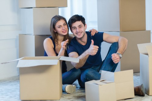 Crew using safe manual handling techniques during a house move